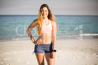 Young woman standing on shore at beach