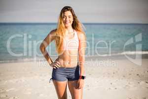 Young woman standing on shore at beach
