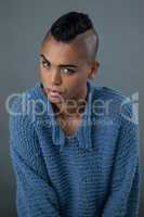 Portrait of transgender woman wearing blue sweater
