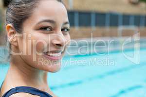 Female swimmer smiling at poolside