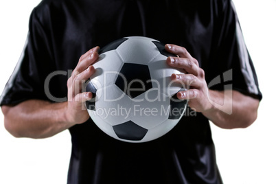 Mid-section of football player holding football with both hands