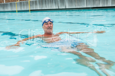 Senior man swimming in pool