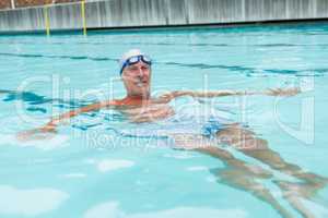 Senior man swimming in pool