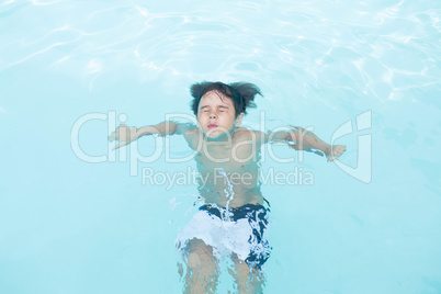 Young boy swimming in pool