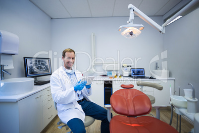 Doctor using digital tablet in dental clinic