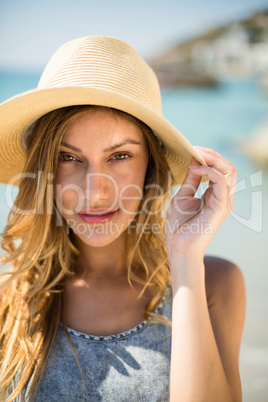Portrait of young woman wearing sun hat