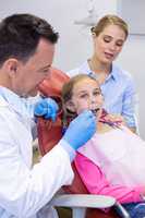 Dentist examining with young patient