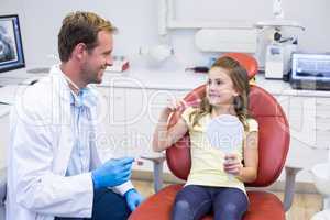 Young patient interacting with dentist in dental clinic