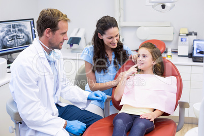 Young patient showing teeth to dentist