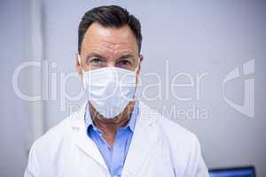 Dentist wearing surgical mask in dental clinic