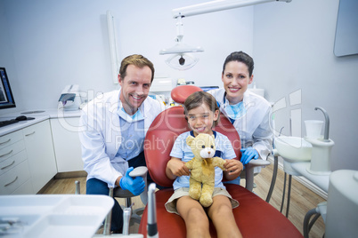 Portrait of smiling dentists and young patient