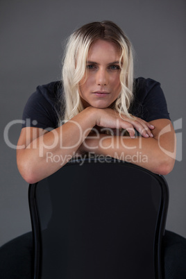 Portrait of beautiful transgender woman leaning on chair