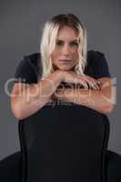 Portrait of beautiful transgender woman leaning on chair