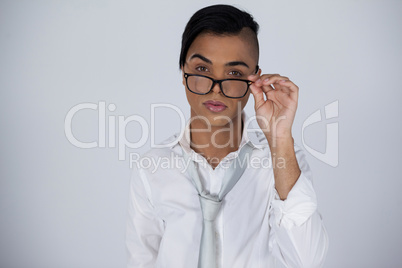Portrait of transgender woman adjusting eyeglasses