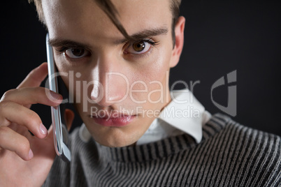 Angry androgynous man talking on mobile phone