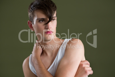 Androgynous man embracing himself