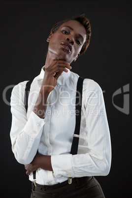 Androgynous man posing with hand on chin