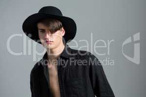 Androgynous man in hat posing
