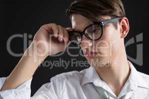 Androgynous man posing in spectacles