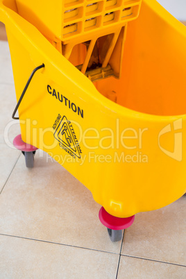 Close up of yellow mop bucket