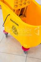 Close up of yellow mop bucket