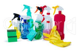 Close up of colorful spray bottles with sponges and gloves