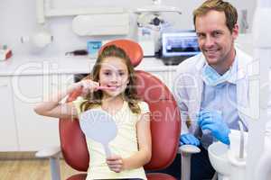 Smiling young patient with a dentist in dental clinic