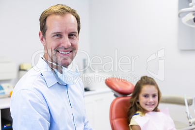 Portrait of smiling dentist and young patient