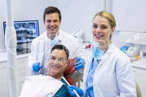 Portrait of smiling dentists and male patient