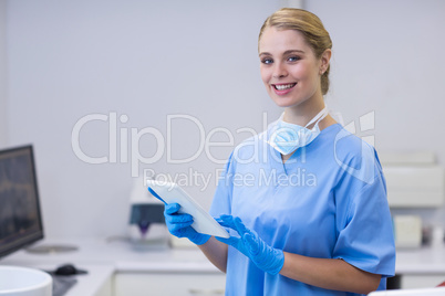 Portrait of smiling nurse using digital tablet