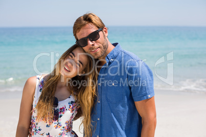 Young couple standing at on sunny day