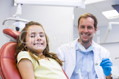 Portrait of smiling dentist and young patient