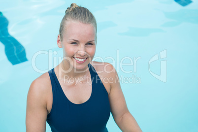 Portrait of fit woman standing in pool