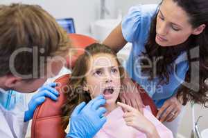 Dentist examining young patient