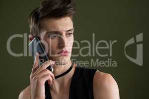 Androgynous man talking on mobile phone
