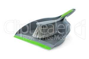 Close-up of gray dustpan with brush