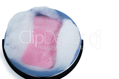 HIgh angle view of cleaning sponge in bucket with soap sud