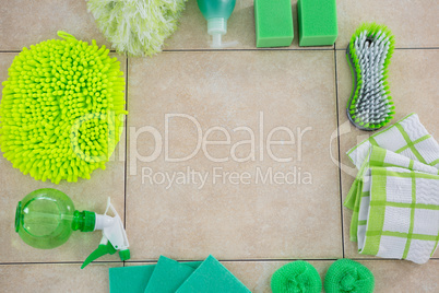Overhead view of green cleaning products arranged floor