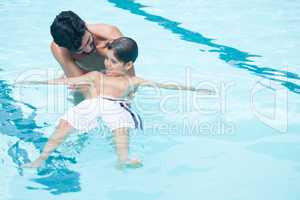 Father and son playing in pool