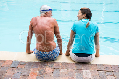 Swim coach interacting with senior man
