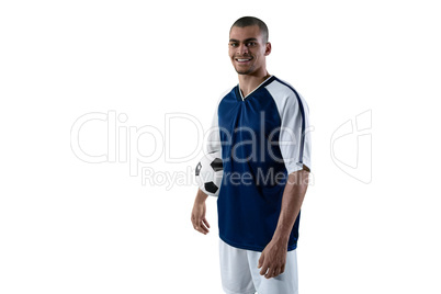 Smiling football player holding football