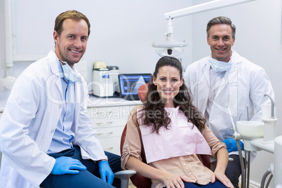 Portrait of smiling dentists and female patient