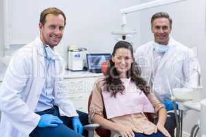 Portrait of smiling dentists and female patient