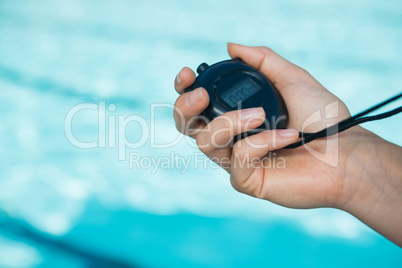 Hand of coach holding stopwatch