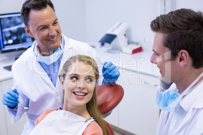 Dentists interacting with female patient