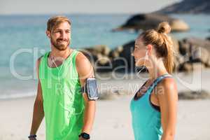 Couple listening music while standing at beach