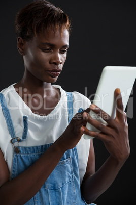 Androgynous man using digital tablet