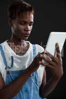 Androgynous man using digital tablet