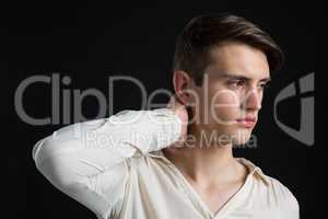Androgynous man posing with hand on his neck