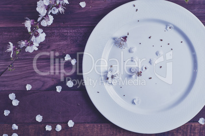 White empty plate on a brown wooden surface